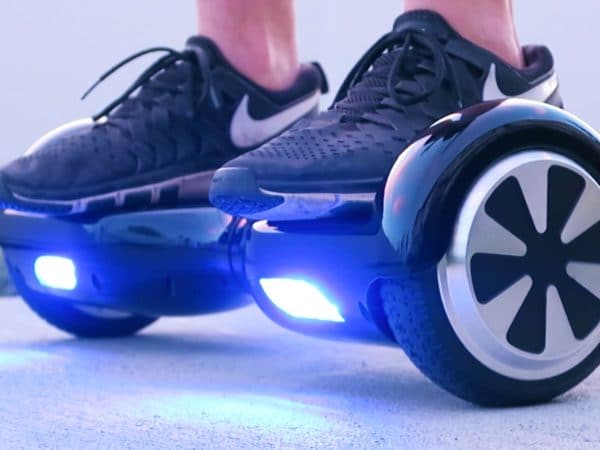 blue hoverboard with black nike shoes on it