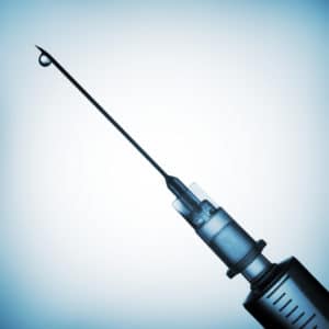 Close-up of medical syringe possibly contaminated with silicone.