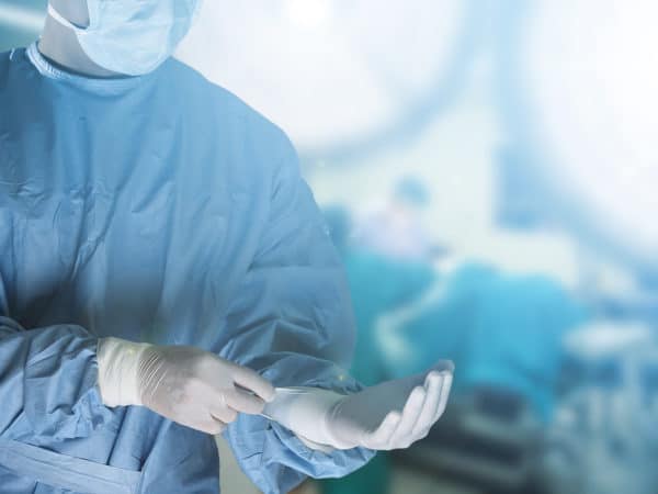 image of surgeon putting on gloves